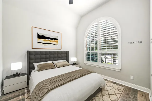 a bedroom with a bed and a painting on the wall