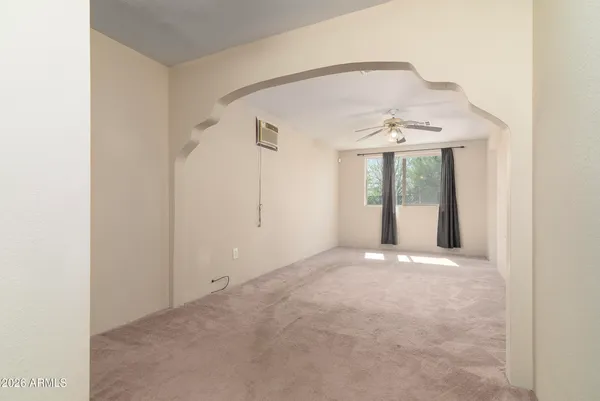 a view of an empty room with a ceiling fan