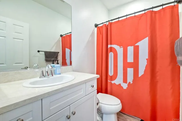 a bathroom with a sink a toilet and a mirror
