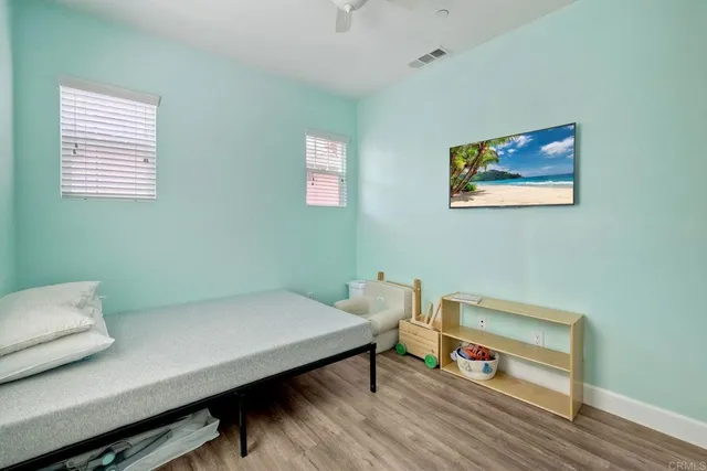 a reading room with furniture and a wooden floor