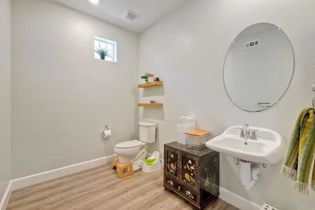 a bathroom with a sink mirror and toilet