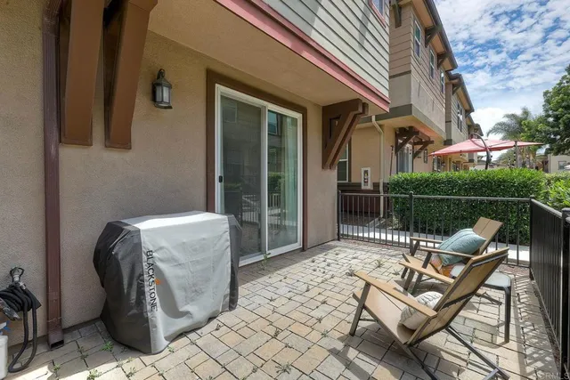 a view of a patio with a table and chairs