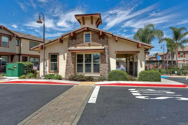 a view of a house with swimming pool and sitting area