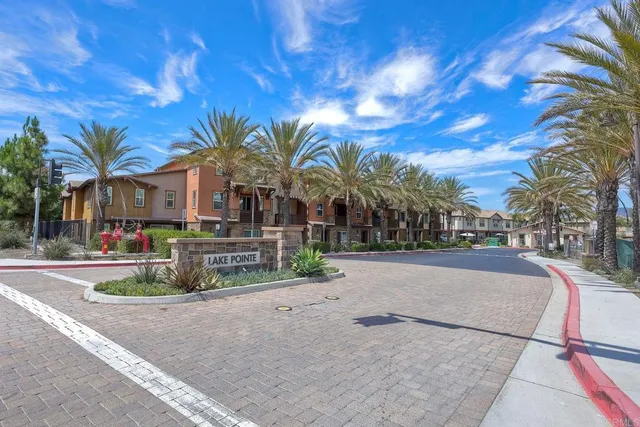 a patio with a table and chairs under an umbrella