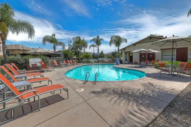 an aerial view of a house with a garden and parking
