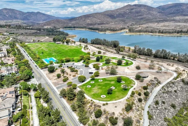 an aerial view of a houses with a lake