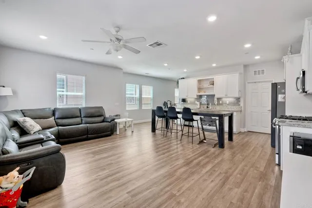 a living room with furniture and kitchen view