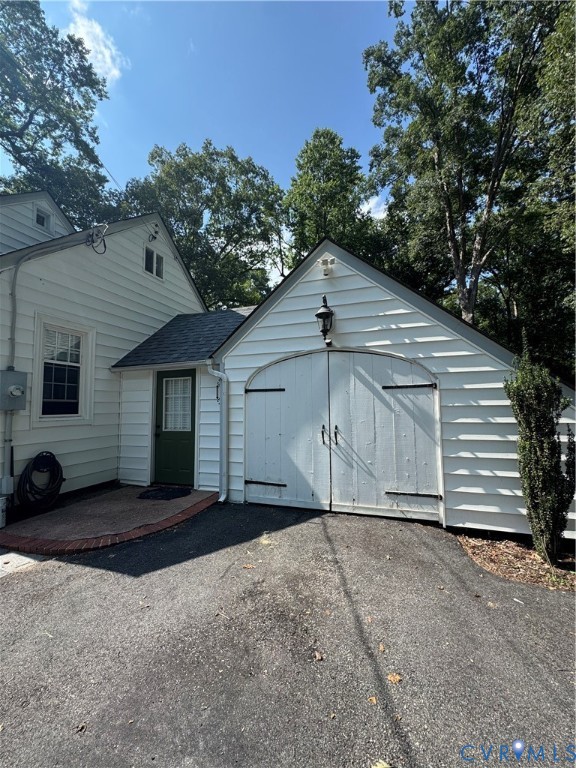 2720 Osborne Road Chester, VA 23831 - Photo 2 of 3 Detached garage with white horizontal siding and a
