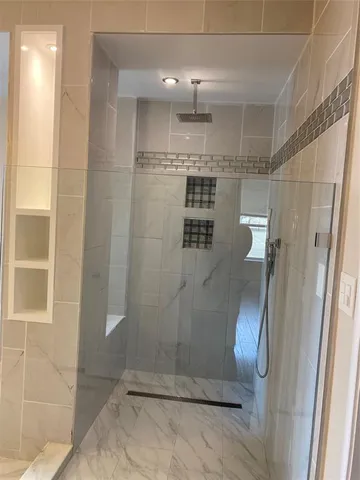 a bathroom with a glass shower door