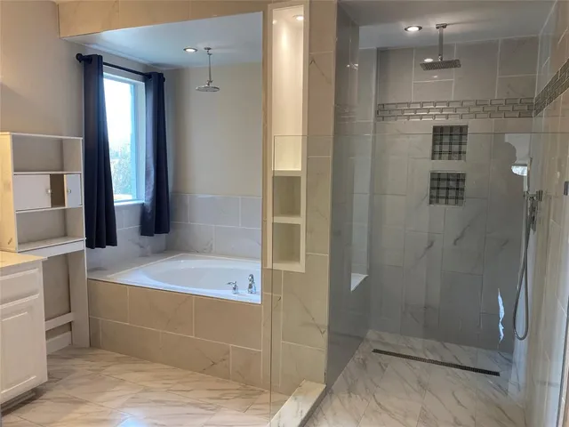a bathroom with a granite countertop sink a toilet and shower