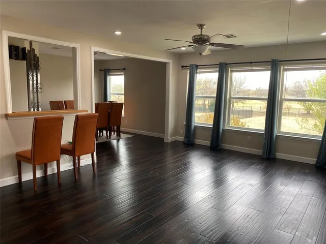 a view of a livingroom with furniture window and wooden floor