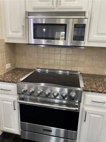 a stove top oven sitting inside of a kitchen