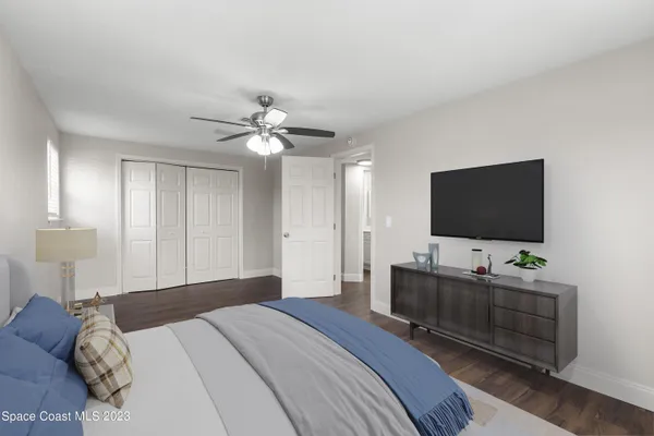 a bedroom with a bed and a flat screen tv