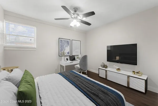 a bedroom with a bed and a flat screen tv