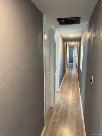 a view of hallway with wooden floor