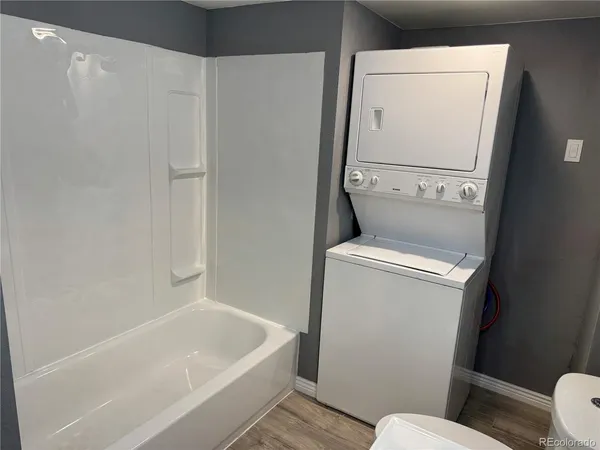 a white bath tub sitting next to a toilet