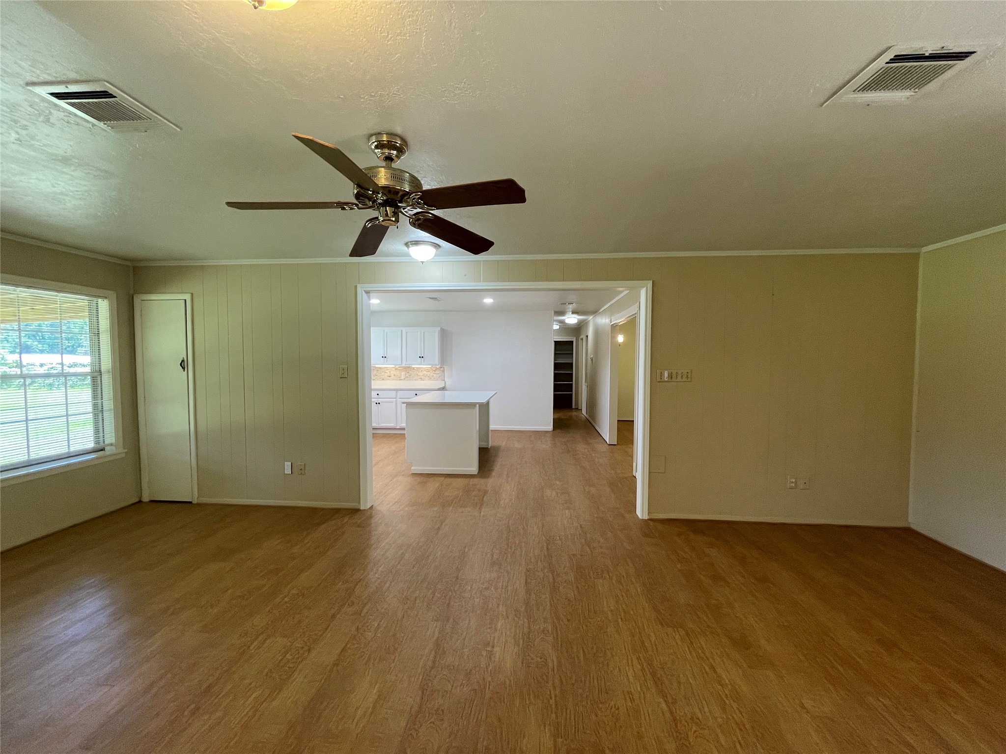 19439 Keenan Cut Off Road Montgomery, TX 77316 - Photo 10 of 39 a view of a room with wooden floor a ceiling fan and windows