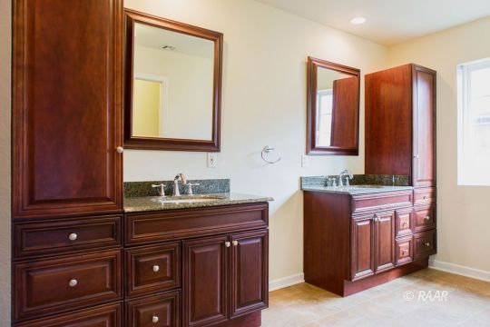 1633 South Farragut Street Ridgecrest, CA 93555 - Photo 24 of 30 a bathroom with a granite countertop sink and a mirror
