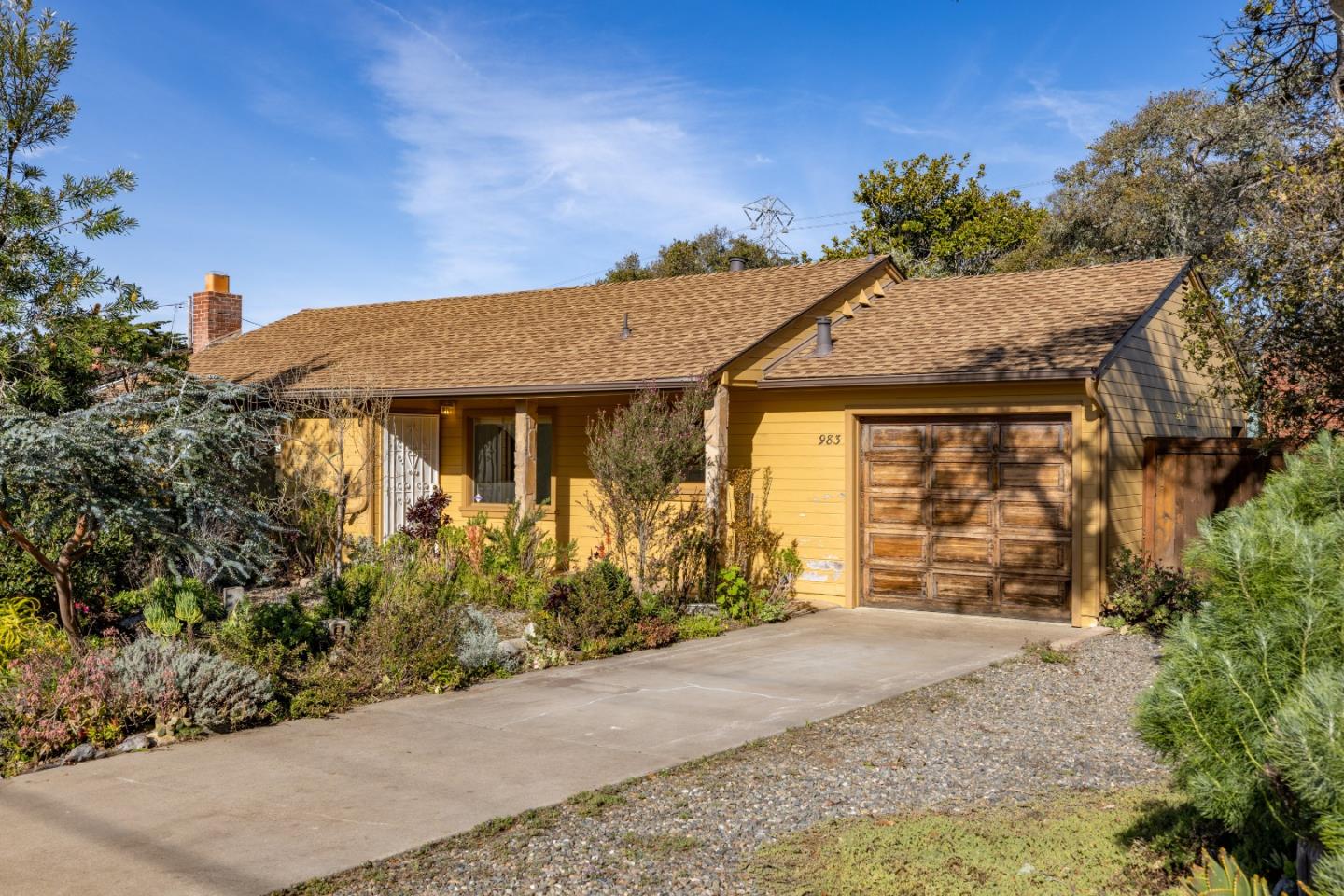 983 Portola Drive Del Rey Oaks, CA 93940 - Photo 1 of 1 a front view of a house with a garden