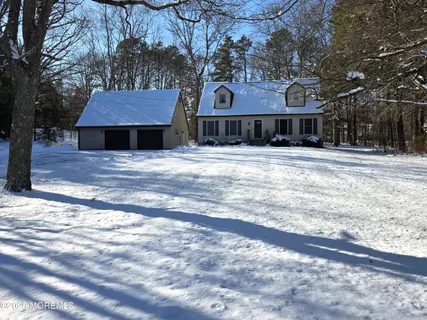 a front view of a building with a garden