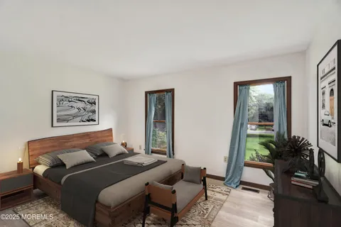 a bedroom with a bed and a potted plant