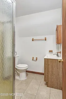 a bathroom with a toilet a sink and vanity