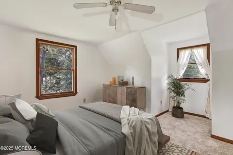 a bedroom with furniture and a window