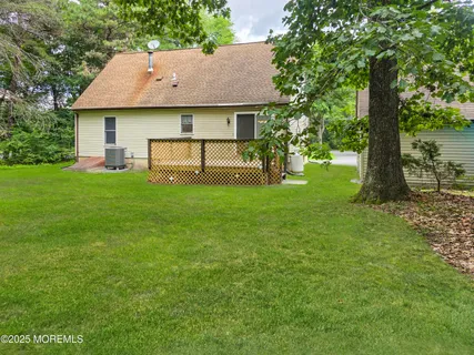 a front view of a house with yard and green space