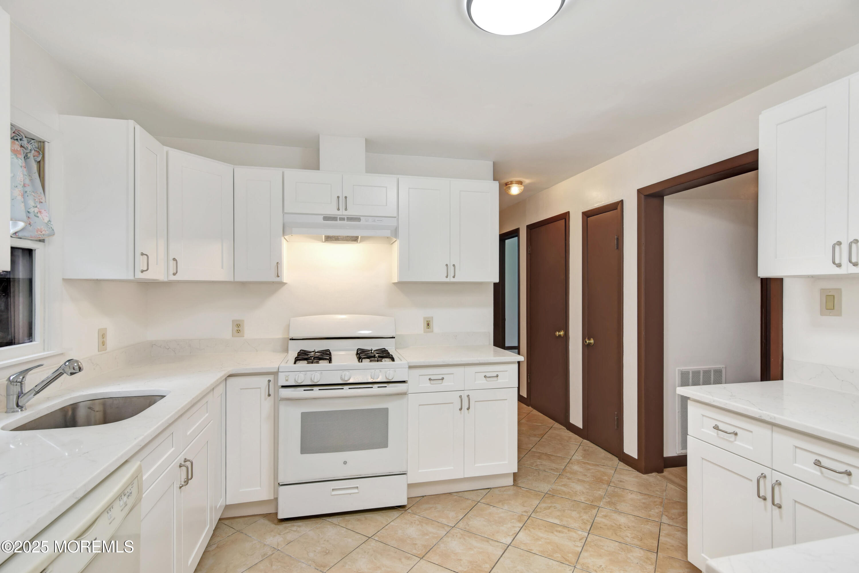 370 Cassville Road Jackson, NJ 08527 - Photo 8 of 18 a kitchen with white cabinets and white appliances