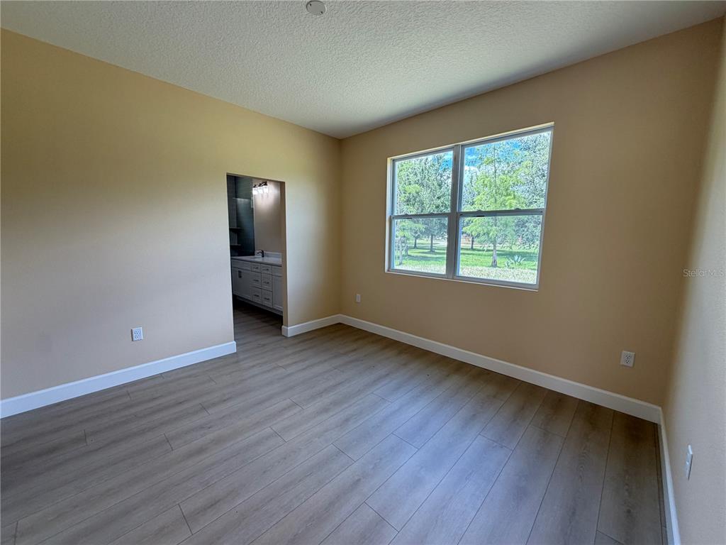4661 Hickory Tree Road St. Cloud, FL 34772 - Photo 20 of 20 a view of an empty room with wooden floor and a window