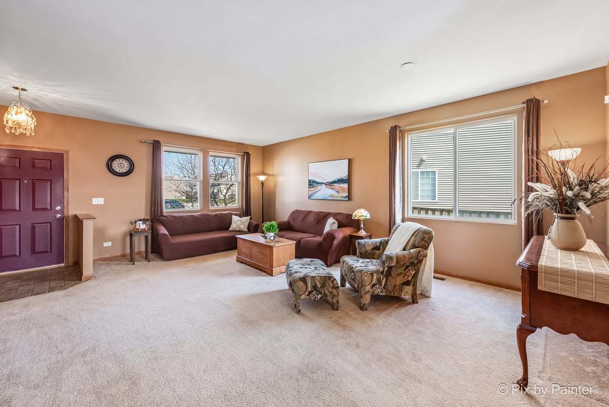 1106 Port Royal Road Pingree Grove, IL 60140 - Photo 13 of 36 a living room with furniture and a window