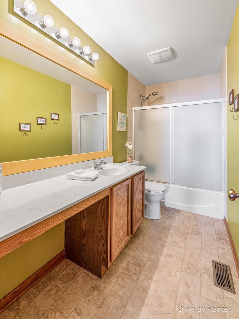 1106 Port Royal Road Pingree Grove, IL 60140 - Photo 23 of 36 a bathroom with a sink a toilet and mirror
