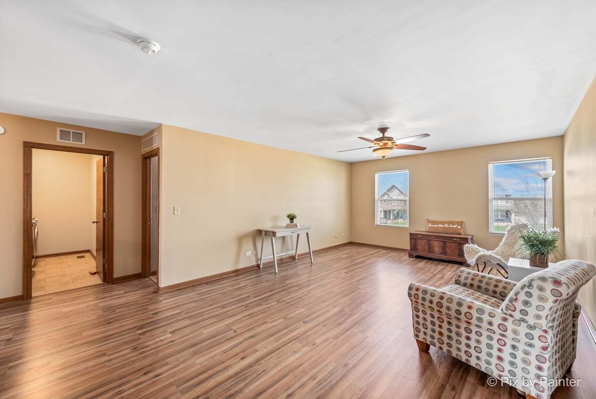 1106 Port Royal Road Pingree Grove, IL 60140 - Photo 5 of 36 a living room with furniture and a wooden floor