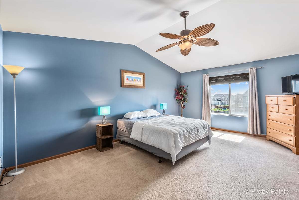 1106 Port Royal Road Pingree Grove, IL 60140 - Photo 6 of 36 a bedroom with a bed and ceiling fan