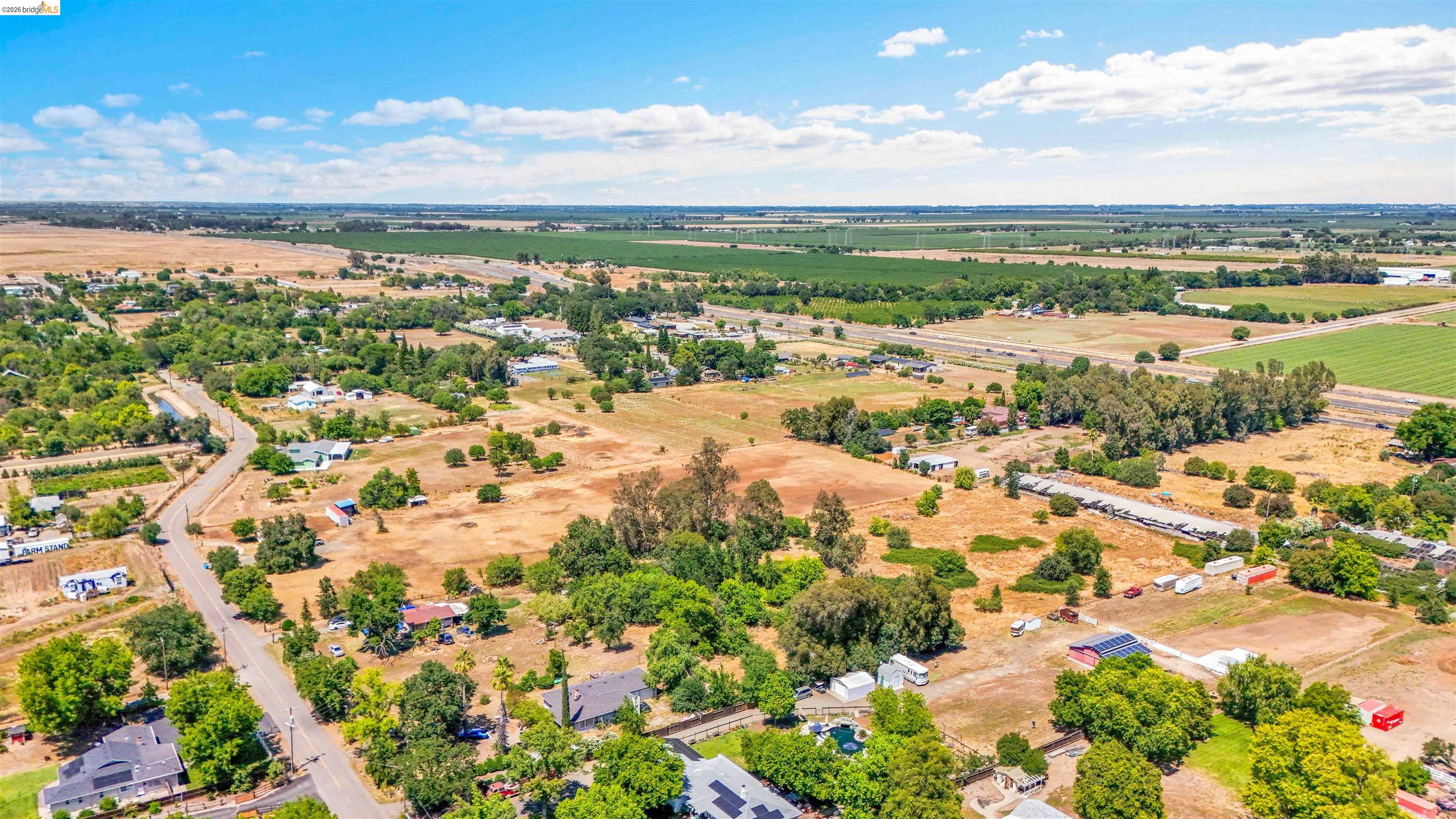 7750 Locke Road Vacaville, CA 95688 - Photo 4 of 23 Expansive rural landscape featuring a network of roads, scattered residential structures, and agricultural fields