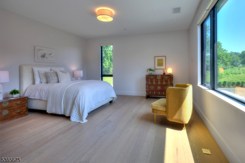51 Abby Road Peapack, NJ 07977 - Photo 20 of 31 a bedroom with a bed and a couch next to a window