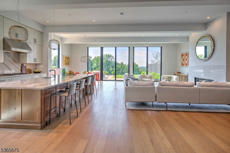 51 Abby Road Peapack, NJ 07977 - Photo 2 of 31 a living room with stainless steel appliances granite countertop a stove a kitchen island a sink and a large window