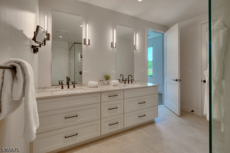 51 Abby Road Peapack, NJ 07977 - Photo 22 of 31 a bathroom with double vanity sink and mirror with shower