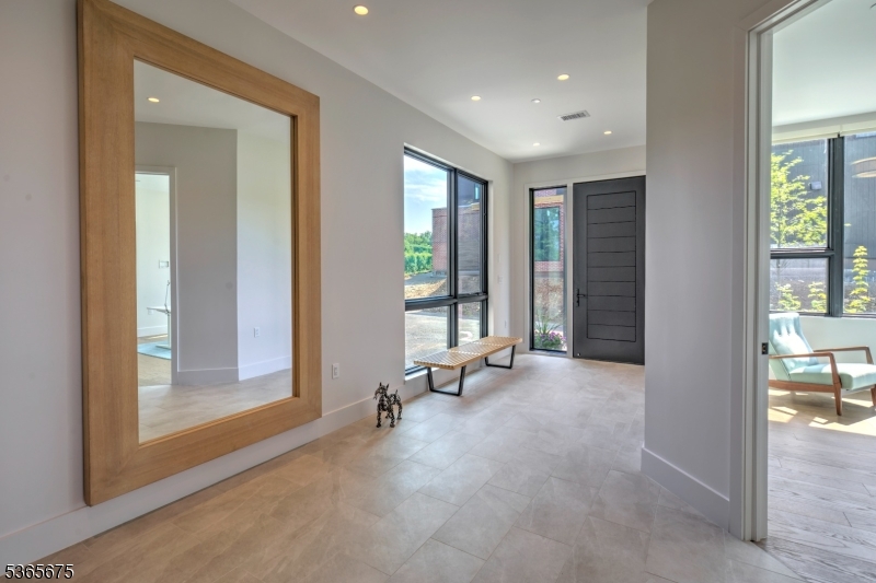 51 Abby Road Peapack, NJ 07977 - Photo 9 of 31 a view of a room with gym equipment and windows