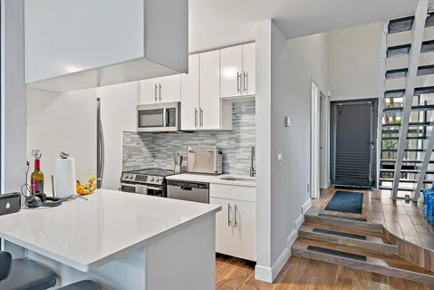 a kitchen with stainless steel appliances a stove refrigerator sink and cabinets