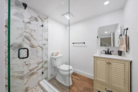 a bathroom with a toilet sink and shower