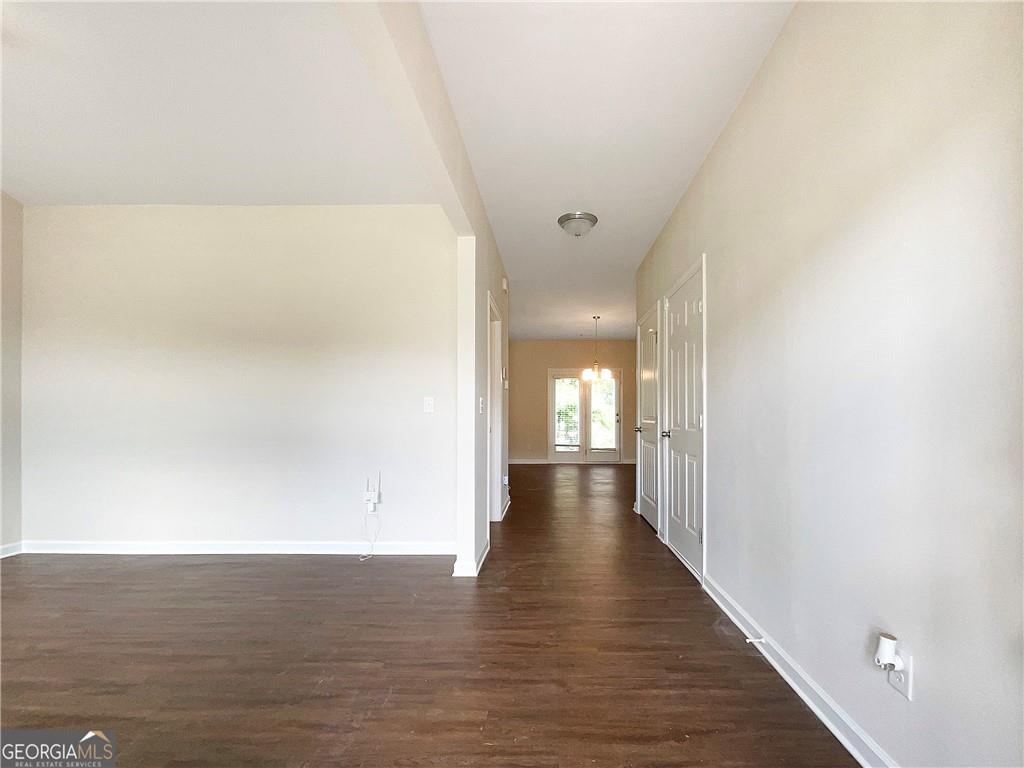 1033 Eldon Lane Fairburn, GA 30213 - Photo 5 of 21 a view of a hallway with wooden floor
