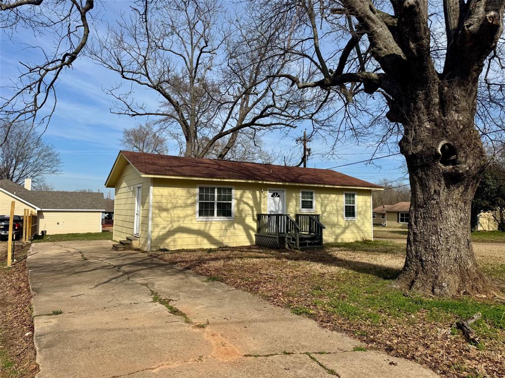 301 Fairview Street Pittsburg, TX 75686 - Photo 1 of 13 a front view of a house with a yard