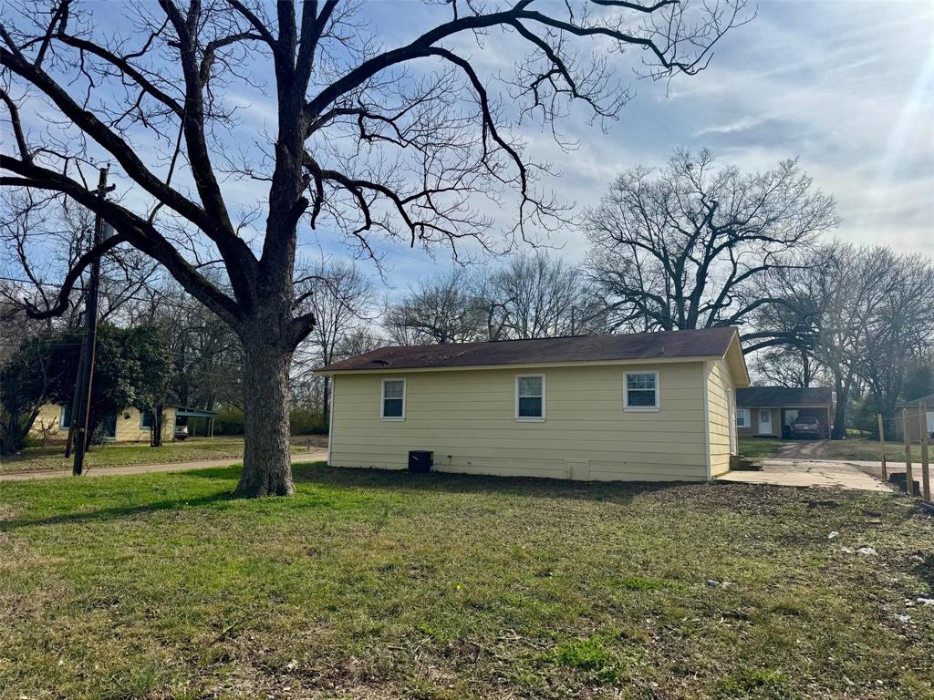 301 Fairview Street Pittsburg, TX 75686 - Photo 12 of 13 a view of a house with a yard
