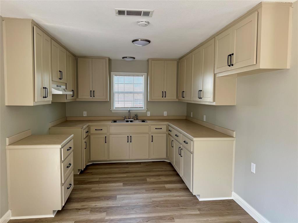 301 Fairview Street Pittsburg, TX 75686 - Photo 3 of 13 a kitchen with granite countertop white cabinets white stainless steel appliances and sink