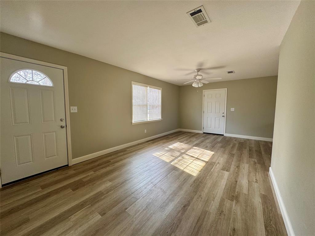 301 Fairview Street Pittsburg, TX 75686 - Photo 5 of 13 a view of empty room with wooden floor and window
