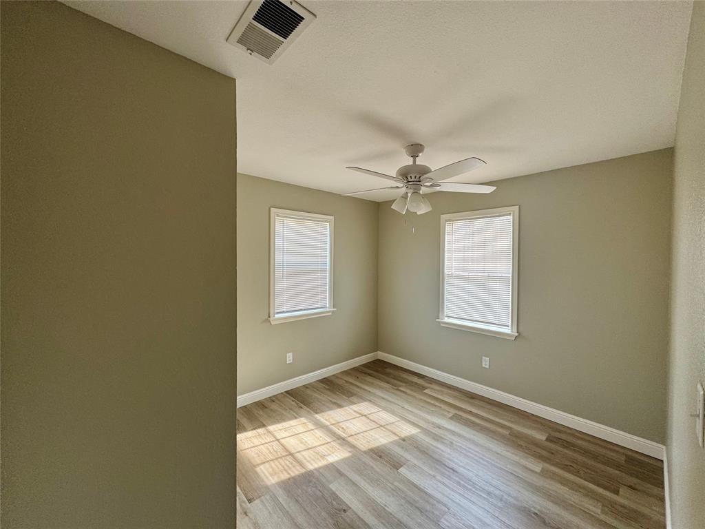 301 Fairview Street Pittsburg, TX 75686 - Photo 8 of 13 a view of empty room with wooden floor and fan