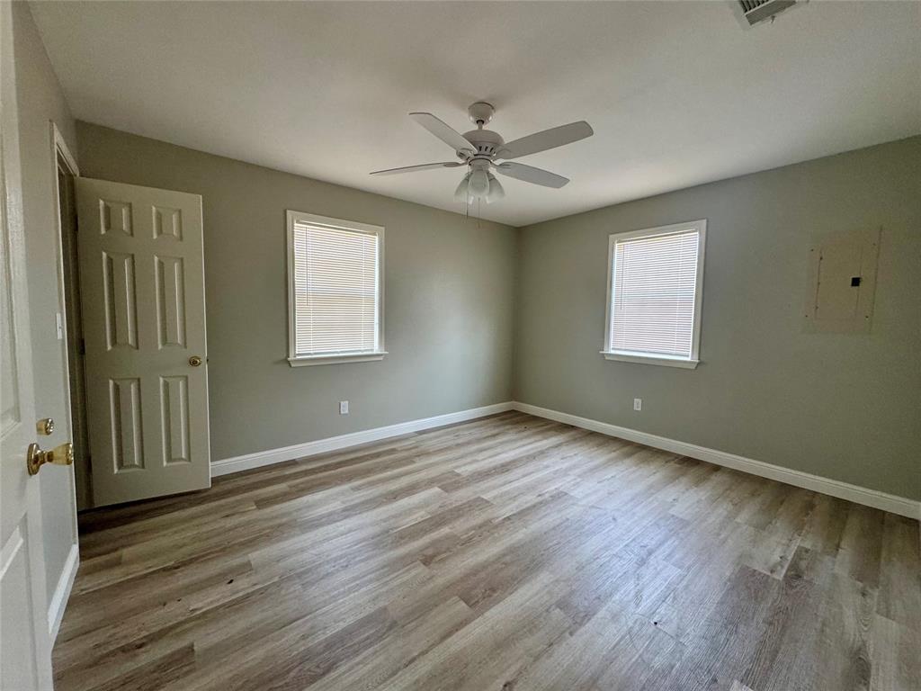 301 Fairview Street Pittsburg, TX 75686 - Photo 9 of 13 wooden floor in an empty room with a window