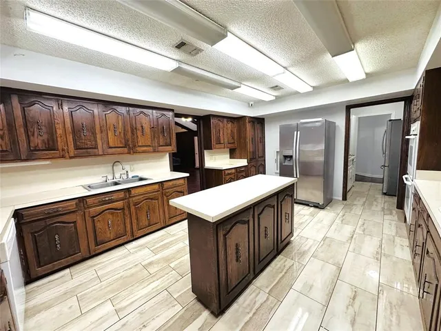 a kitchen with stainless steel appliances granite countertop a sink stove and cabinets
