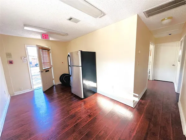 a very nice looking room with wooden floor and a window